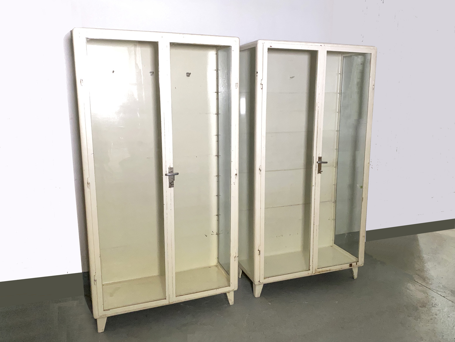 Pair of Vintage Medicine Cabinet Display Cabinet Metal white, Industrial Design Germany, 1950’s. Comes with four Glass Shelves each. Unrestored.
