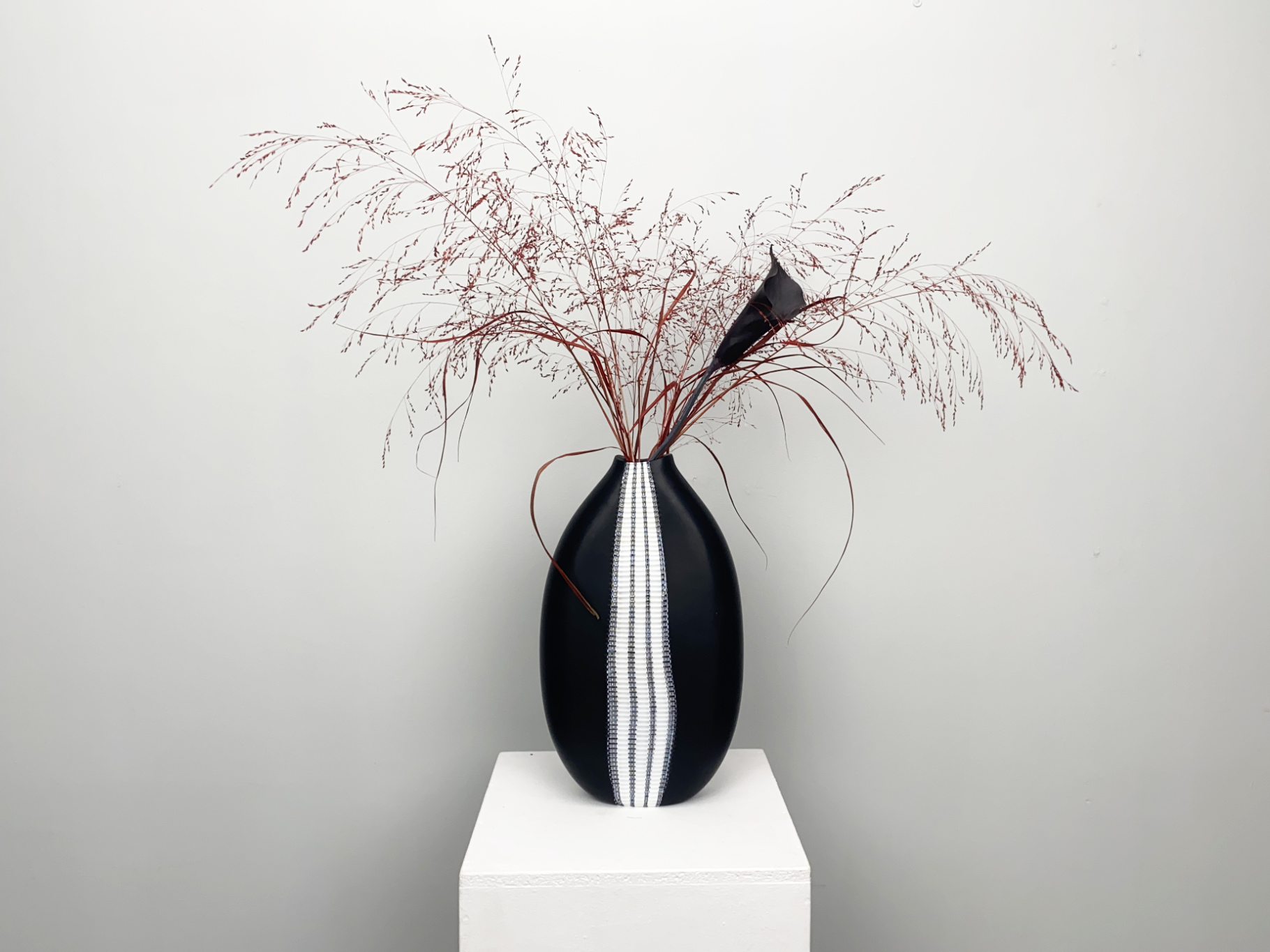 Glass Vase “Vessel“ by Andrea Zilio for Anfora Murano 2007. Black glass, colourlessly overlaid on the inside, with a wide, fused vertical band with rows of black and white patterned murrines, alternating with white vertical stripes
